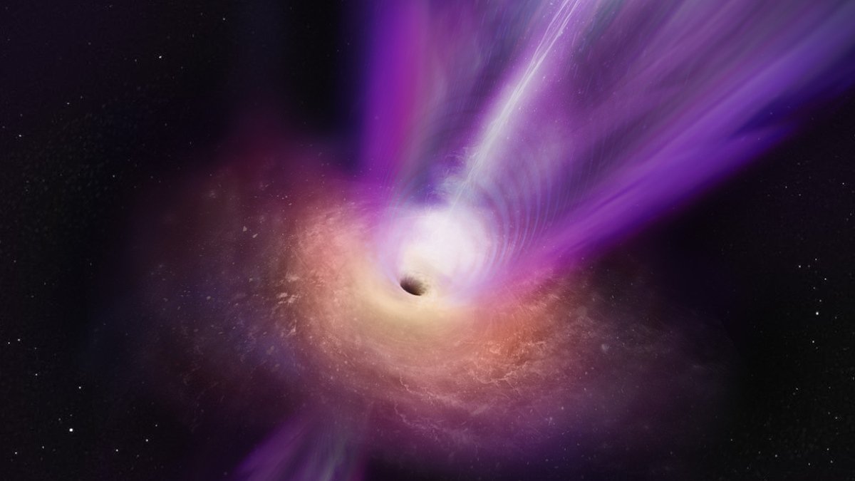 Ett ljust område med svart ring i mitten, lila stråle som skjuter ut upp åt höger i bilden.